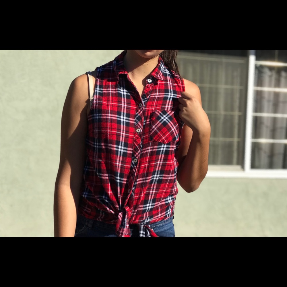 Red, sleeveless, plaid button down T-shirt.